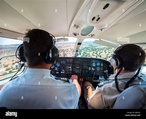 Two Pilots In The Cockpit Controlling The Small Aircraft Cessna 406