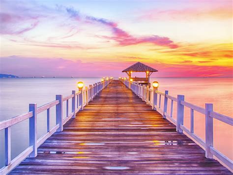 sunset pier lamps water sea beach sky  red clouds