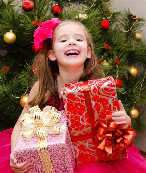 Little Girl With T Boxes Near Christmas Tree Stock Image Image Of