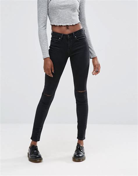 asos asos lisbon skinny mid rise jeans in washed black with two displaced ripped knees at asos