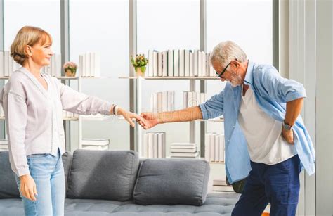 Portrait Of Happy Senior Couple Dancing In Living Room Elderly Woman