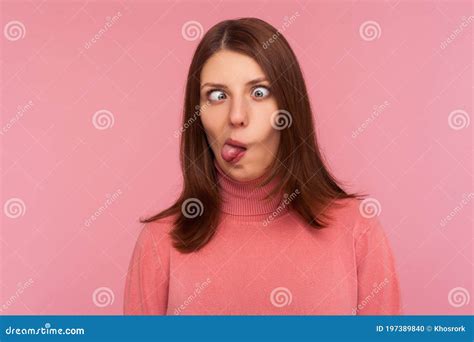 Closeup Portrait Of Funny Crazy Woman Crossing Eyes And Showing Tongue Having Fun Making Dumb