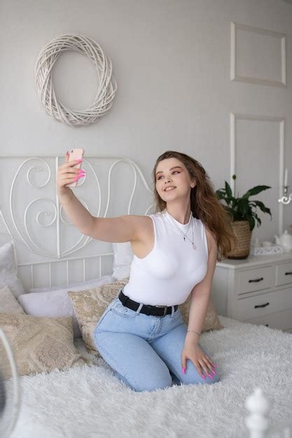 Premium Photo A Happy Woman Has A Selfie The Girl Looks Into The Phone Camera And Smiles
