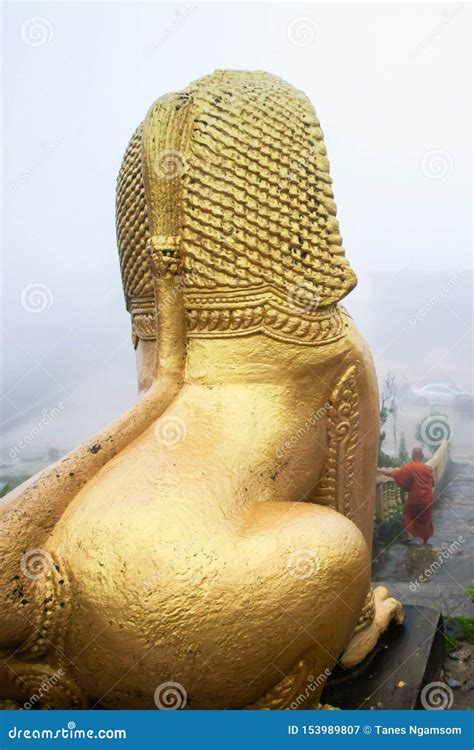 A Khmer Monk And The Giant Singha Khmer Statue In The Mist Royalty Free