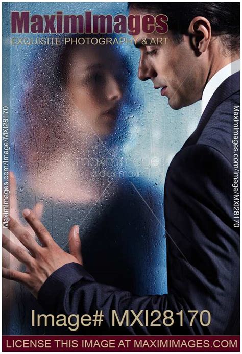 Stock photo: Couple separated by wet glass pane ...