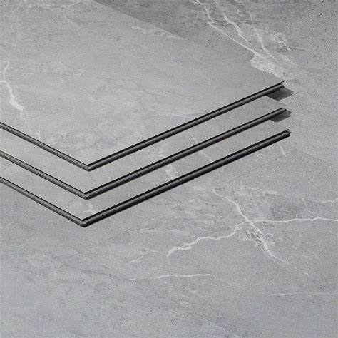 Three Pieces Of Metal Sitting On Top Of A Gray Floor