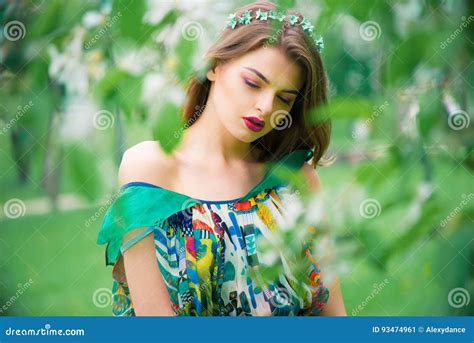 Attractive Beautiful Young Model In Colorful Dress In Summer Garden