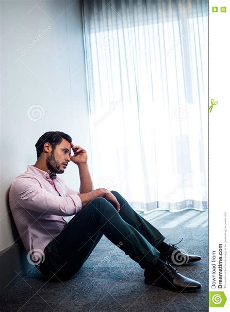 Upset Businessman Sitting Against The Wall Stock Image Image Of