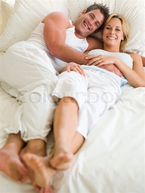 man and women laying on a bed stock image colourbox