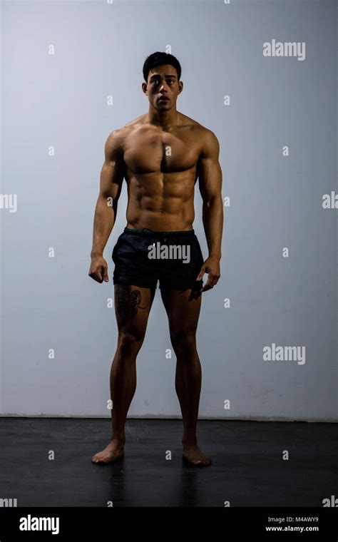 An Asian Fitness Model Full Body Shot Looking Directly At The Camera