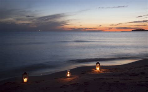 Lanterns On A Deserted Beach At Sunset By Ltapsah