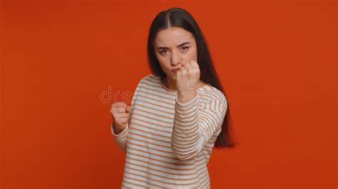 angry aggressive woman trying to fight at camera shaking fist boxing with expression