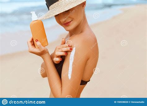 Beautiful Woman In Bikini Applying Sun Cream On Tanned Shoulder Sun Protection Stock Photo