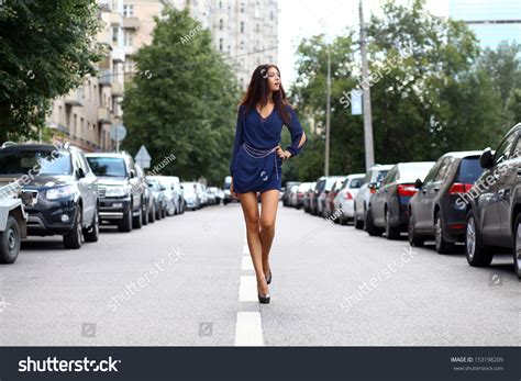 Beautiful Young Woman Walking On The Street Stock Photo 153198209