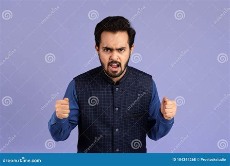Millennial Indian Man Clenching His Fists In Anger Against Color