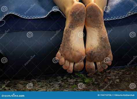 Dirty Feet In The Ground Of A Barefoot Girl Close Up Stock Photo