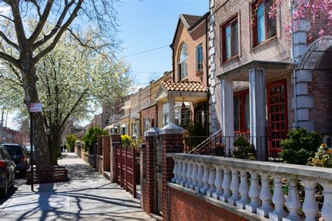 Row Of Beautiful Homes Along A Sidewalk During Spring In Astoria Queens