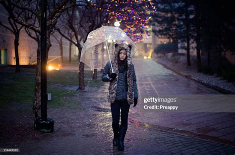 Woman With Clear Umbrella Walking In The Rain High Res Stock Photo