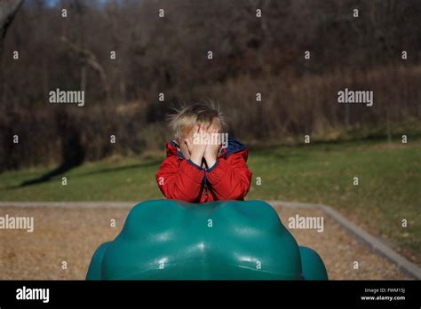 Boy Hiding Face At Playground Stock Photo Alamy
