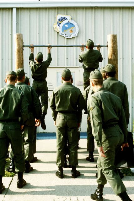 Combat Control School Students Are Doing Pull Ups On A Chinning Bar As
