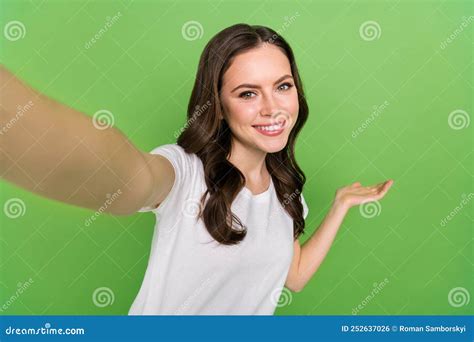 Photo Of Dreamy Cute Young Lady Wear White T Shirt Recording Self Video Showing Arm Empty Space