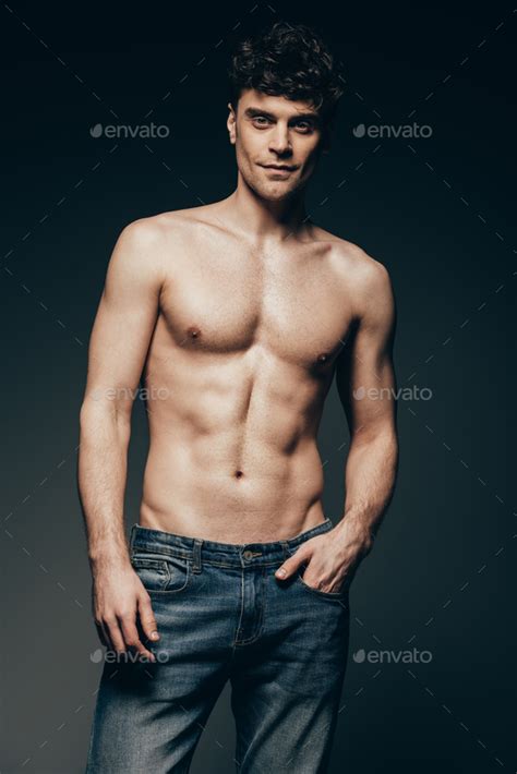 Handsome Shirtless Man In Jeans Posing Isolated On Dark Grey Stock