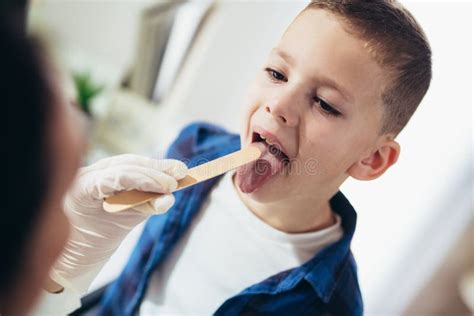 Pediatrician Checks The Throat Of A Boy Stock Photo Image Of