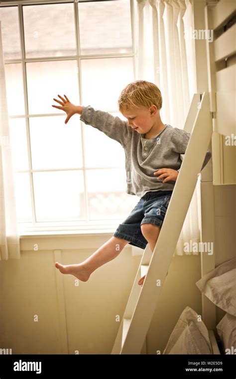Little Boy Climbing Down His Bunk Bed Ladder Stock Photo Alamy