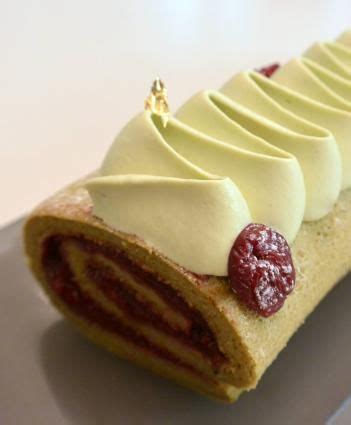 A Pastry With White Frosting And Raspberries On It