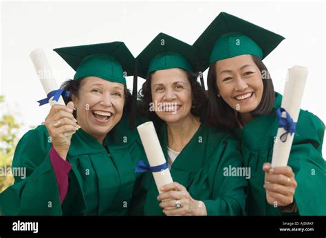 Senior Graduates Hoisting Diplomas Outside Portrait Stock Photo Alamy