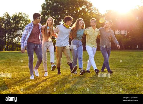 Group Of Happy Multiracial Friends Walking Park Enjoying Summer And