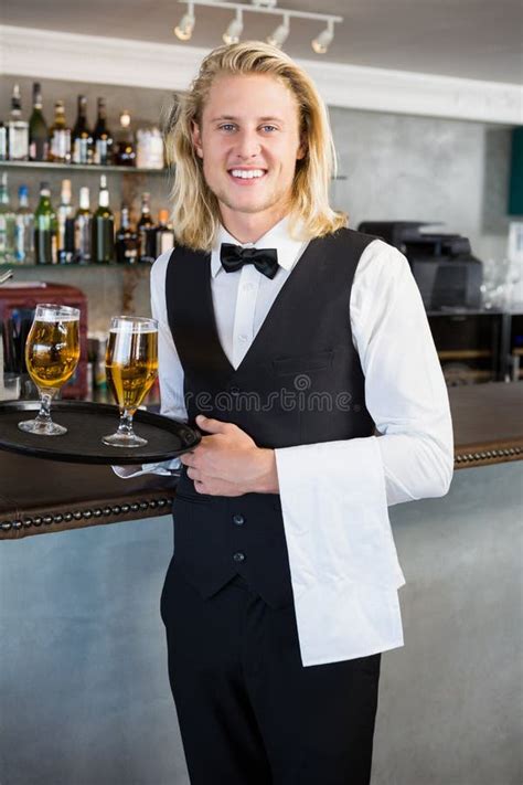 Portrait Of Waiter Holding Tray With Glasses Of Beer Stock Image