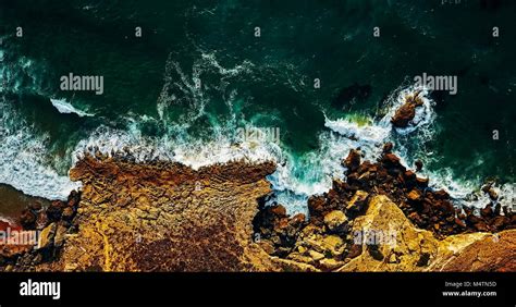 Aerial View From Flying Drone Of Ocean Waves Crushing On Rocky Beach