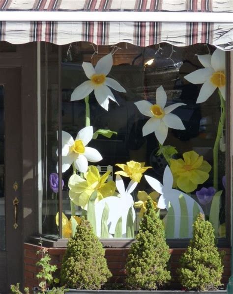 The Window Is Decorated With White And Yellow Flowers