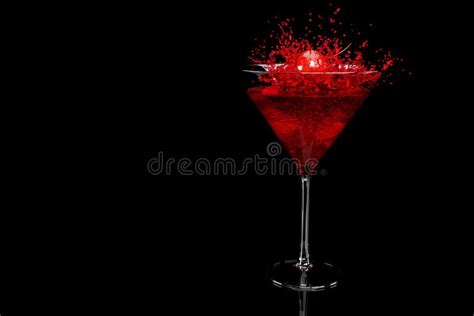 cherry falling into splashing cocktail in martini glass isolated on black stock image image of