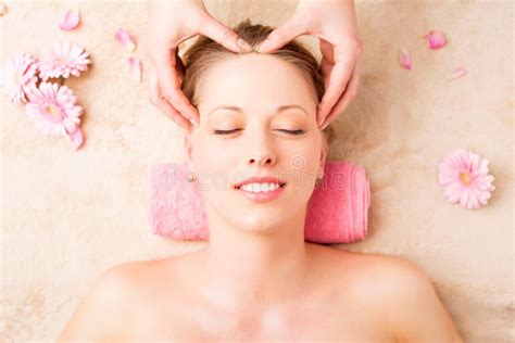 Beautiful Woman Enjoying Facial Massage At Spa Studio Stock Photo