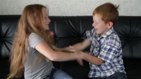 Brother And Sister Fighting And Playing On Sofa Stock Video Envato
