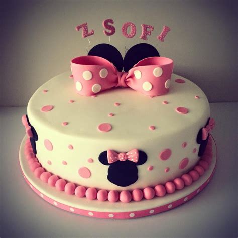A Minnie Mouse Cake With Pink And White Polka Dots On It S Bottom Tier