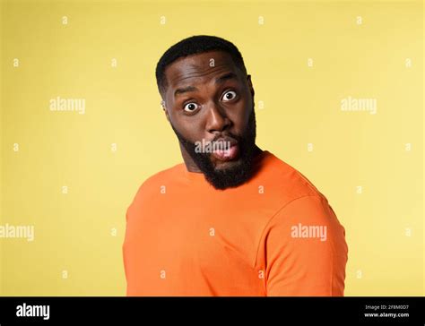 Black Man With Surprised And Amazed Expression Yellow Background Stock