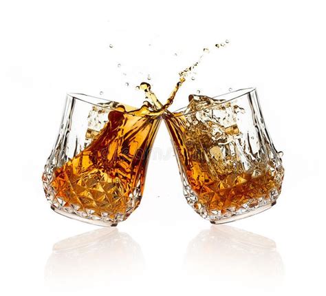 cheers a toast with whiskey two glasses clicking together over white backgroun sponsored