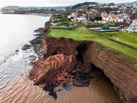 dramatic pictures show huge chunk of rock lying in the sea after cliff fall in latest incident