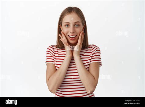 Portrait Of Delighted Smiling Blond Girl Feel Flattered And Touched Looking Surprised At T