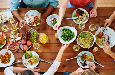 Group Of People Eating At Table With Food Stock Image Image Of