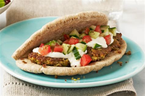 Falafel is stuffed in pita bread with salad and sauce. Falafel Sandwich Recipe | Just A Pinch Recipes