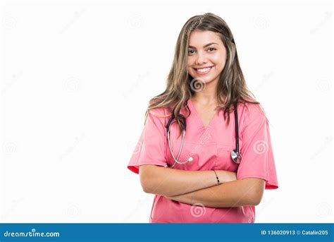 Portrait Of Beautiful Young Doctor Wearing Scrubs Standing With Arms