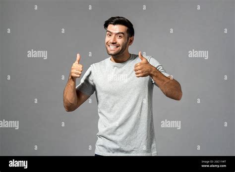Smiling Surprised Young Caucasian Millennial Man With Double Thumbs Up