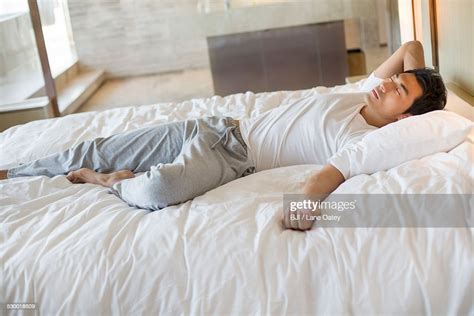 Young Man Sleeping On Bed High Res Stock Photo Getty Images