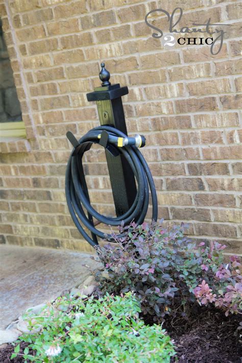 This decorative hose pot eliminates your hose being an eyesore in the yard. Hose Holder for the Garden DIY - Shanty 2 Chic