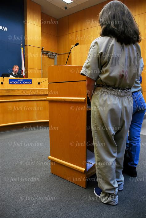 Female Offender In Court In Jumpsuit Standing Before The Judge Joel