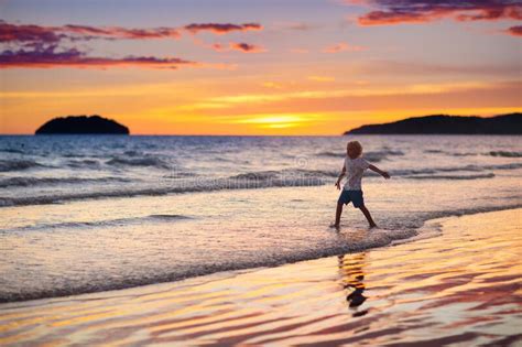 Child Playing On Ocean Beach Kid At Sunset Sea Stock Image Image Of